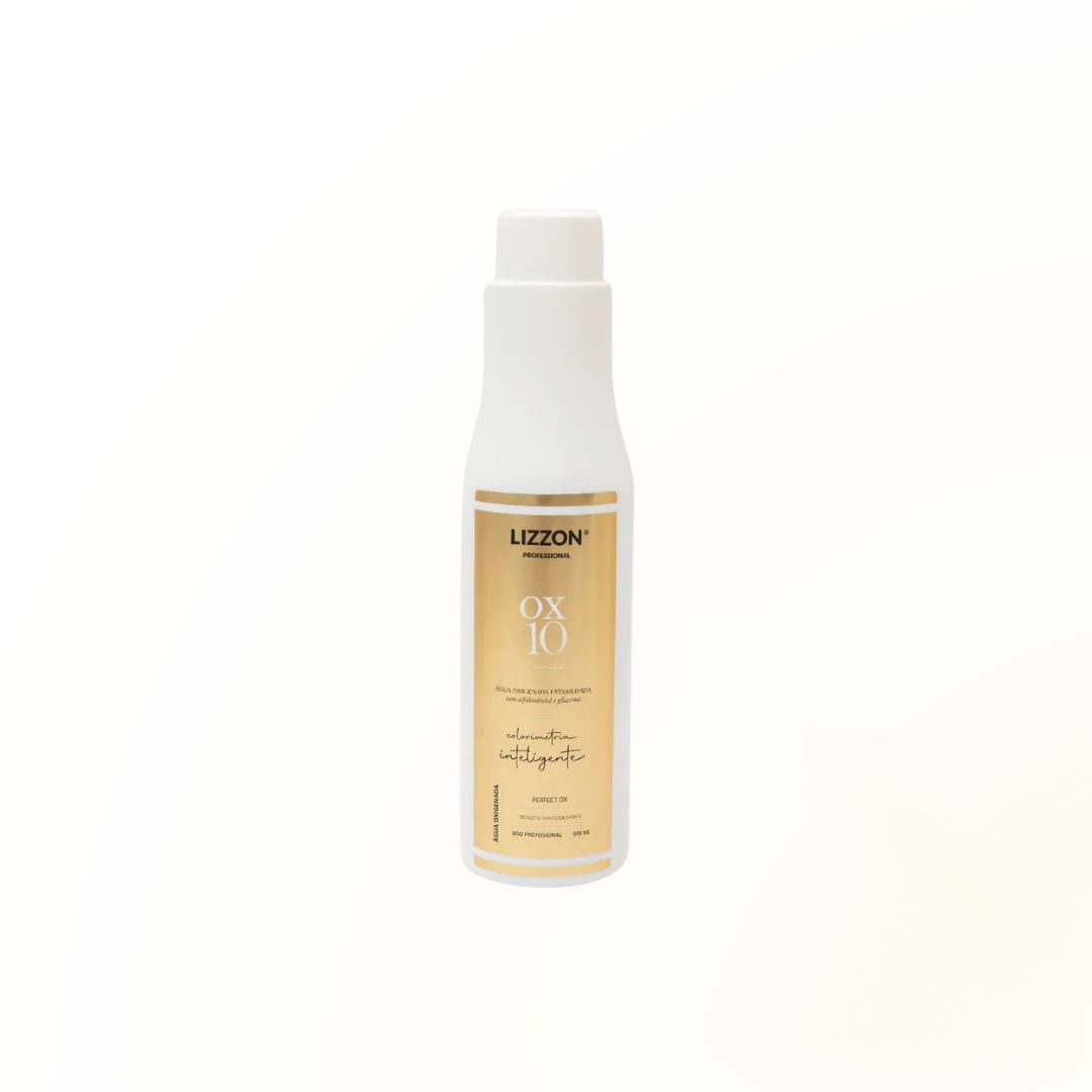 Um frasco branco de revelador em creme PERFECT OX 10V Estabilizada com um rótulo bege e detalhes em dourado é mostrado em um fundo branco liso.