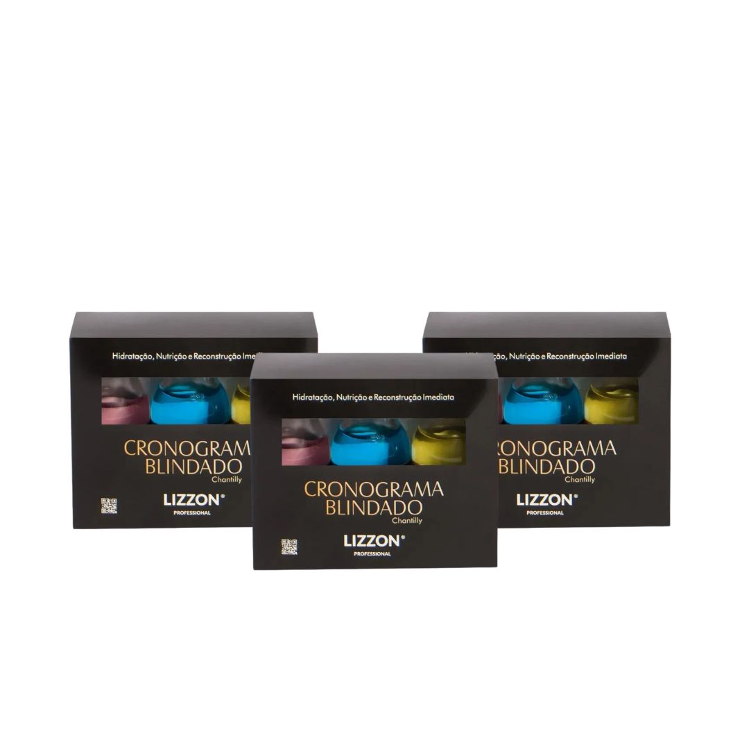 Três caixas pretas com o rótulo "Kit Cronograma Blindado (Combo 3 unidades)" estão dispostas lado a lado, cada uma mostrando frascos azuis, rosas e amarelos - ideais para atualizar sua rotina de cuidados com os cabelos.