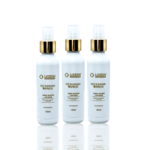 Três frascos idênticos de spray branco com tampas douradas e brancas estão dispostos em uma fileira sobre um fundo branco. Cada frasco de 100 ml é rotulado como Booster Ativador Liso Blindado Express.