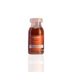 Um frasco de 15 ml de Power Dose Nano Cauterização com líquido marrom, rótulo português laranja e tampa de plástico transparente é mostrado em um fundo branco.