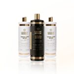 Três garrafas do Kit 3 Volume Control (2 Blond e 1 Tradicional) são exibidas na vertical: a garrafa central é preta com detalhes em dourado, enquanto as duas garrafas laterais são brancas com detalhes em dourado. Todas estão rotuladas como "controle de volume".