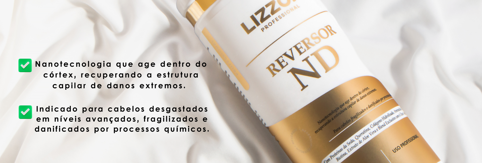reversor ND Lizzon Um frasco branco e dourado do produto para cabelos Lizz Reversor ND da Lizzon repousa sobre um tecido branco. Ao lado, um texto informativo em português destaca sua nanotecnologia para reparar cabelos severamente danificados.